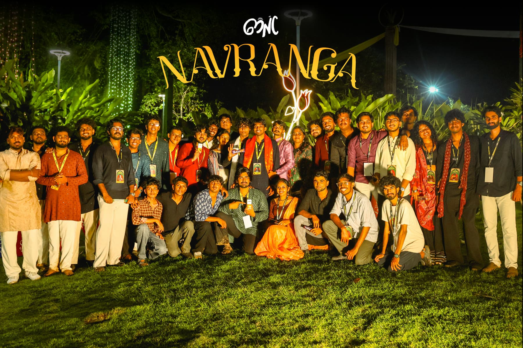 The Navranga crew and volunteers gathered under the illuminated NAVRANGA sign at the Kerala Arts & Crafts Village